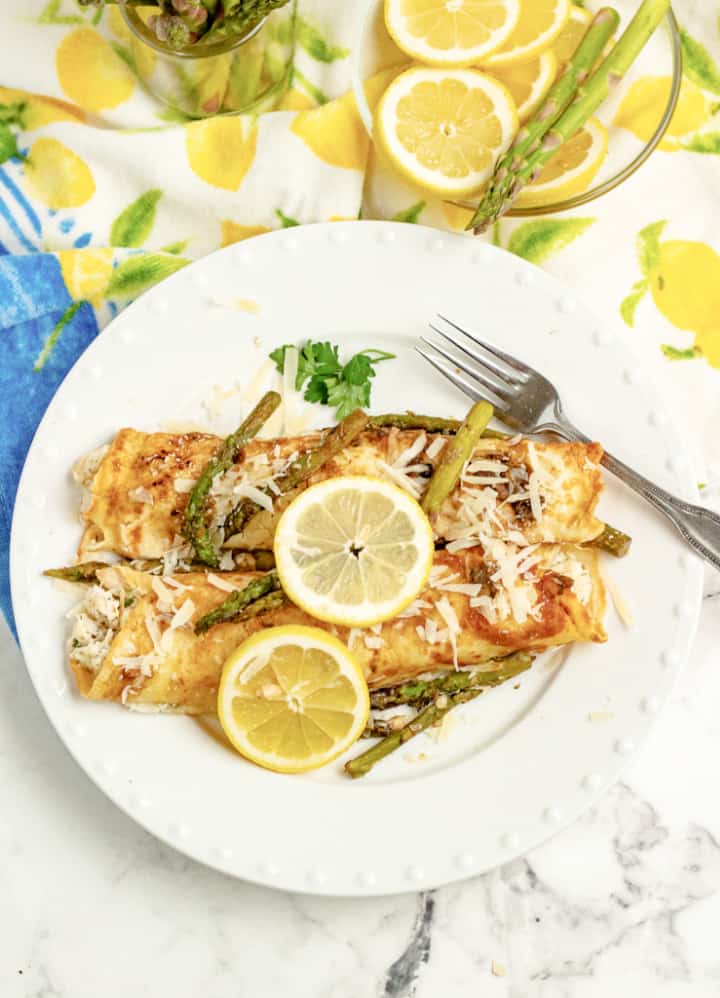 chicken asparagus crepes on white plate