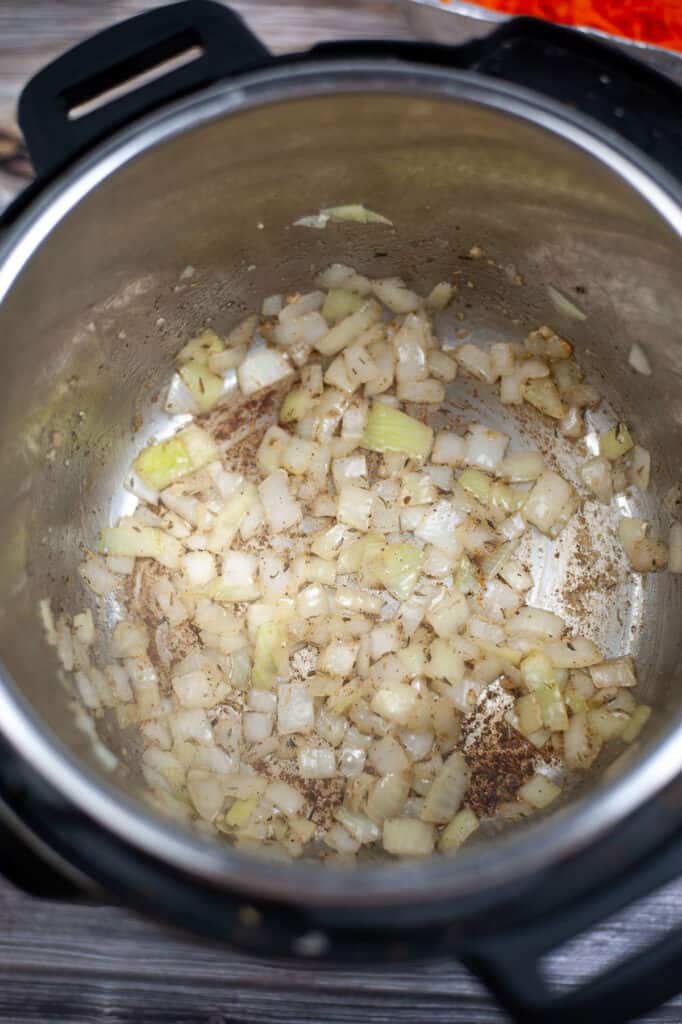 onions and spices sauteing in instant pot